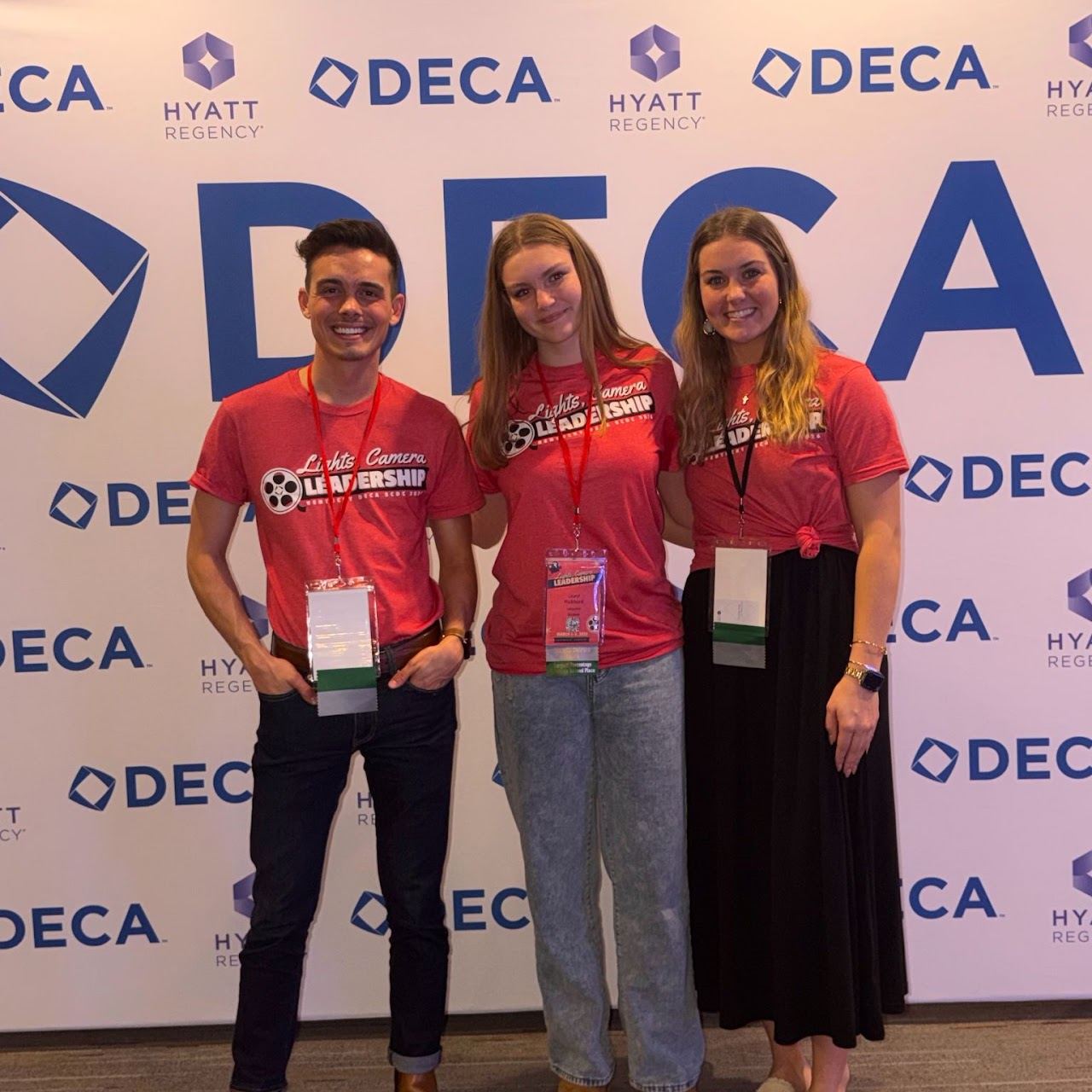 Lafayette DECA members at a conference photo backdrop